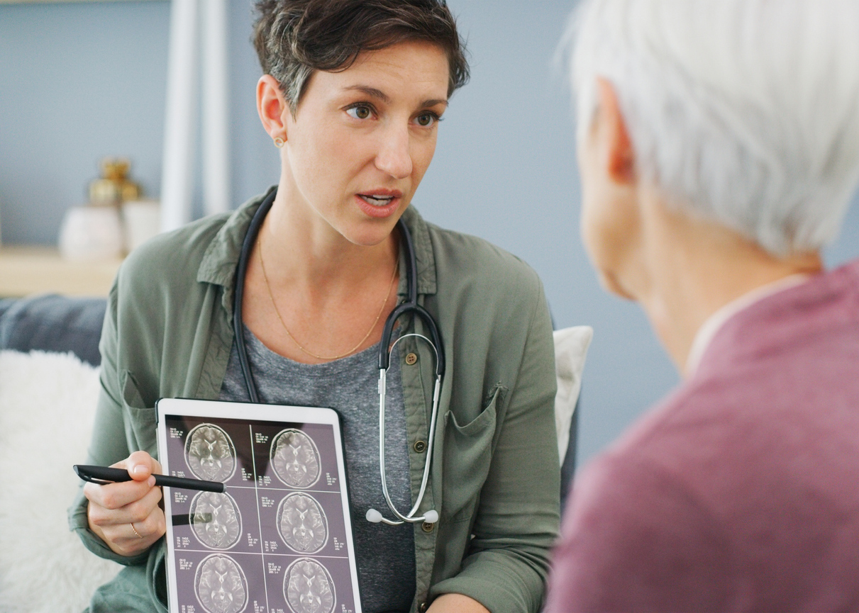 Doctor explaining brain scan to patient.