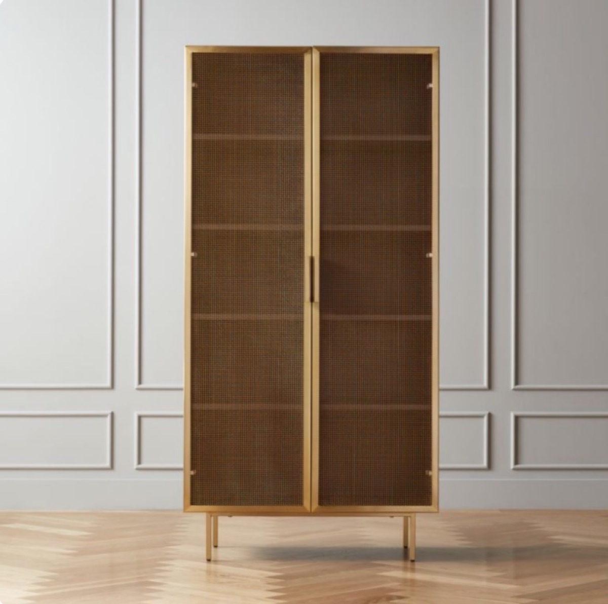 wooden and mesh bookcase in front of gray wall with picture moldings