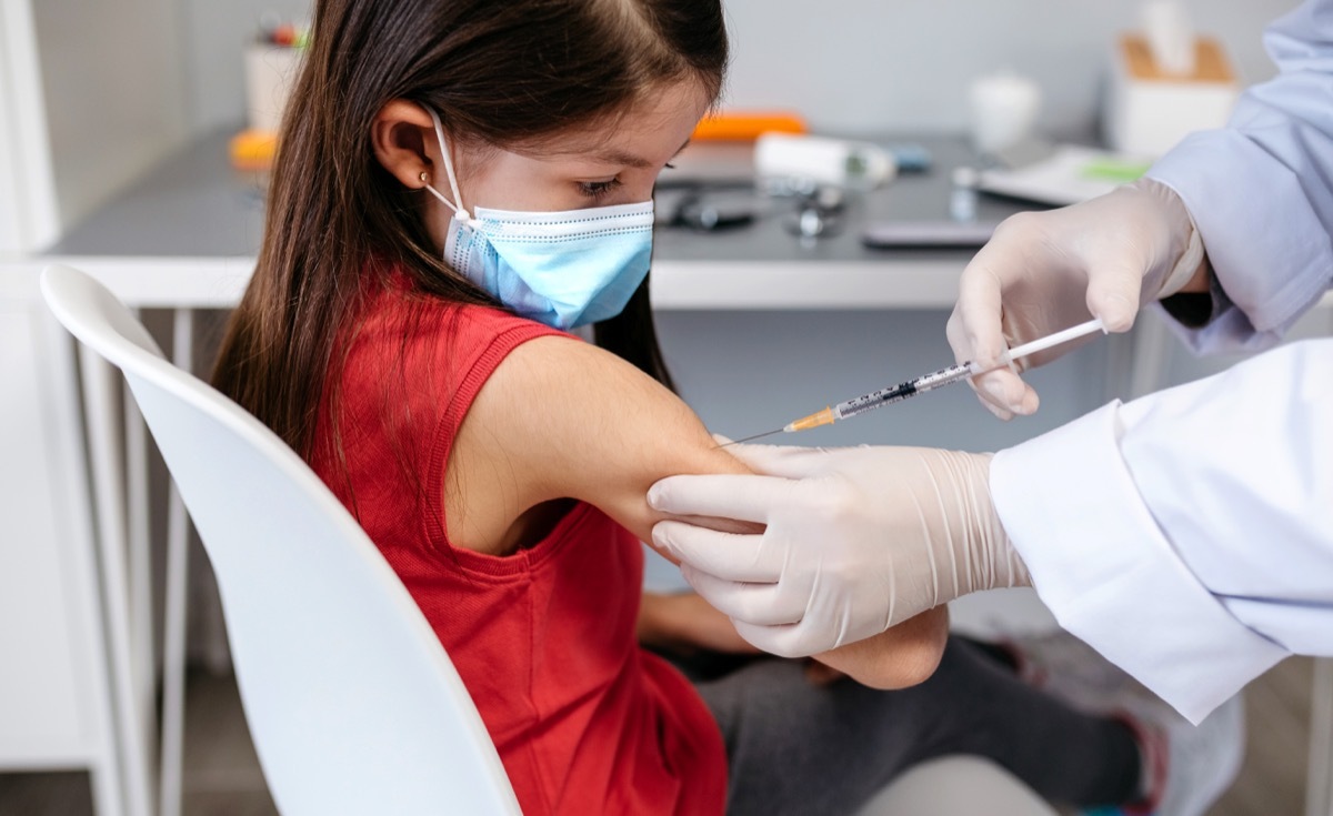 Little girl receiving coronavirus vaccine at doctor's office