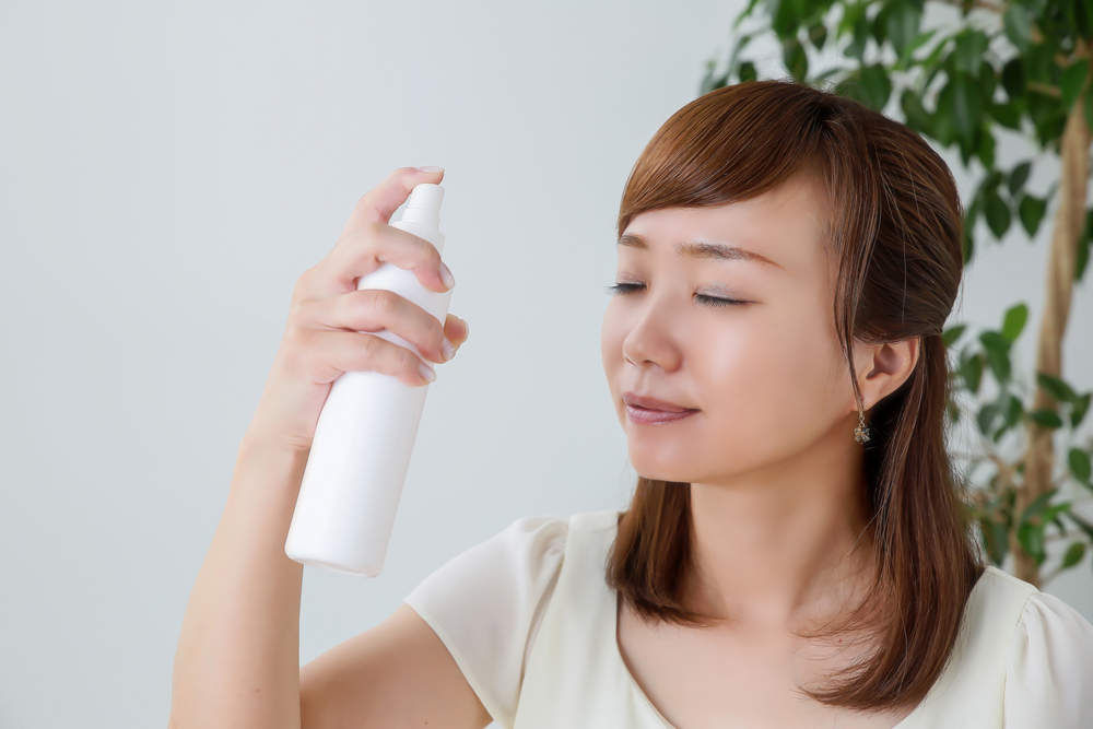 woman using a face mist, healthy skin after 40