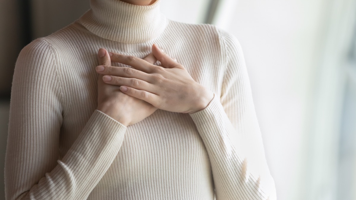 Woman with Both Hands Over her Heart