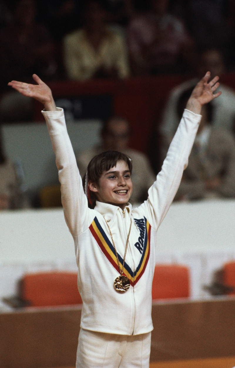 Nadia Comăneci with one of her gold medals at the 1976 Olympics