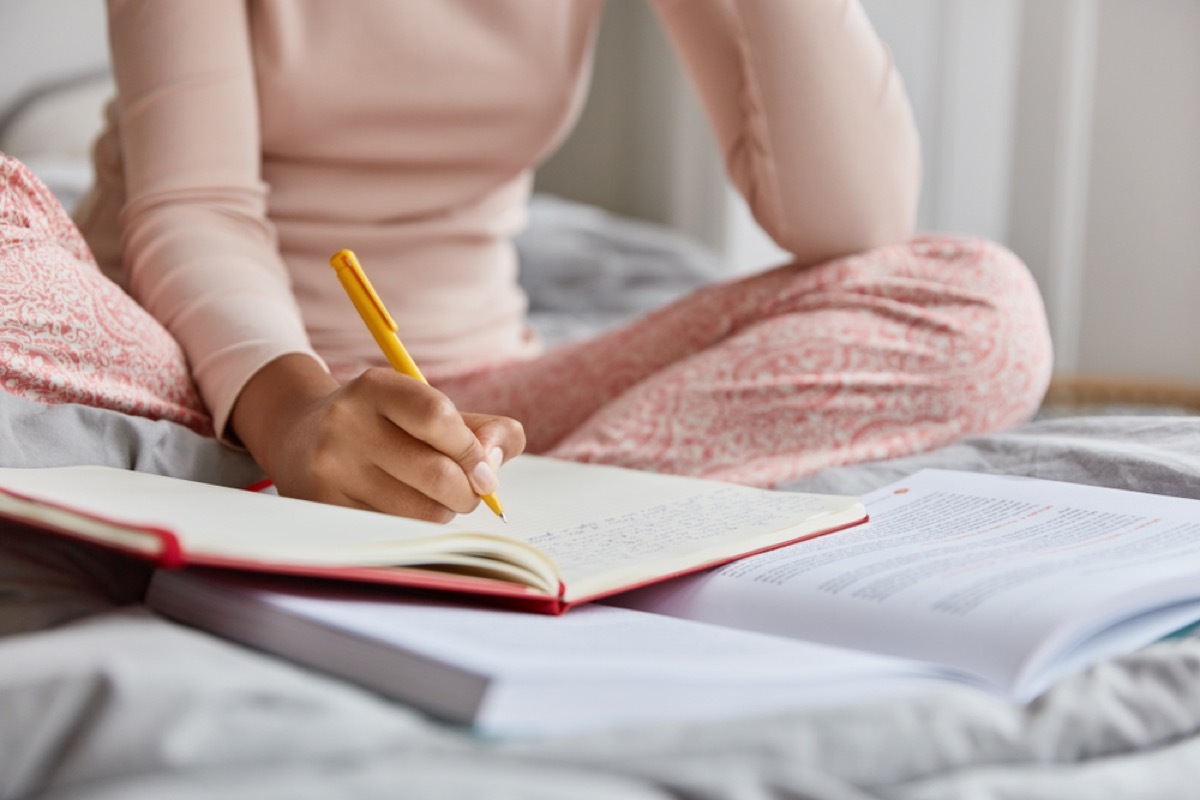 woman journaling in bed