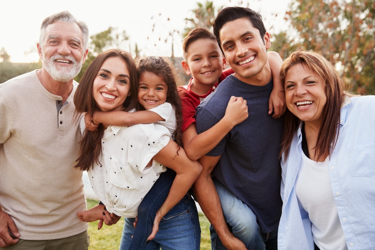 intergenerational family smiling for a photo